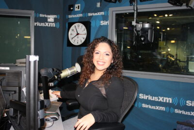 Woman smiling in SiriusXM radio studio